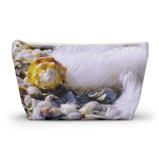 Zippered kit bag featuring vibrant photo art close up of a shell about to be swept up by a crashing wave.