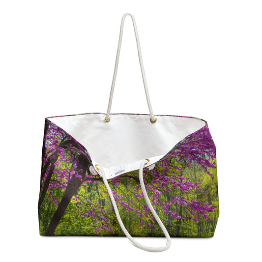 An open view of the beach bag with tree blossoms design shows the cream colored interior lining.