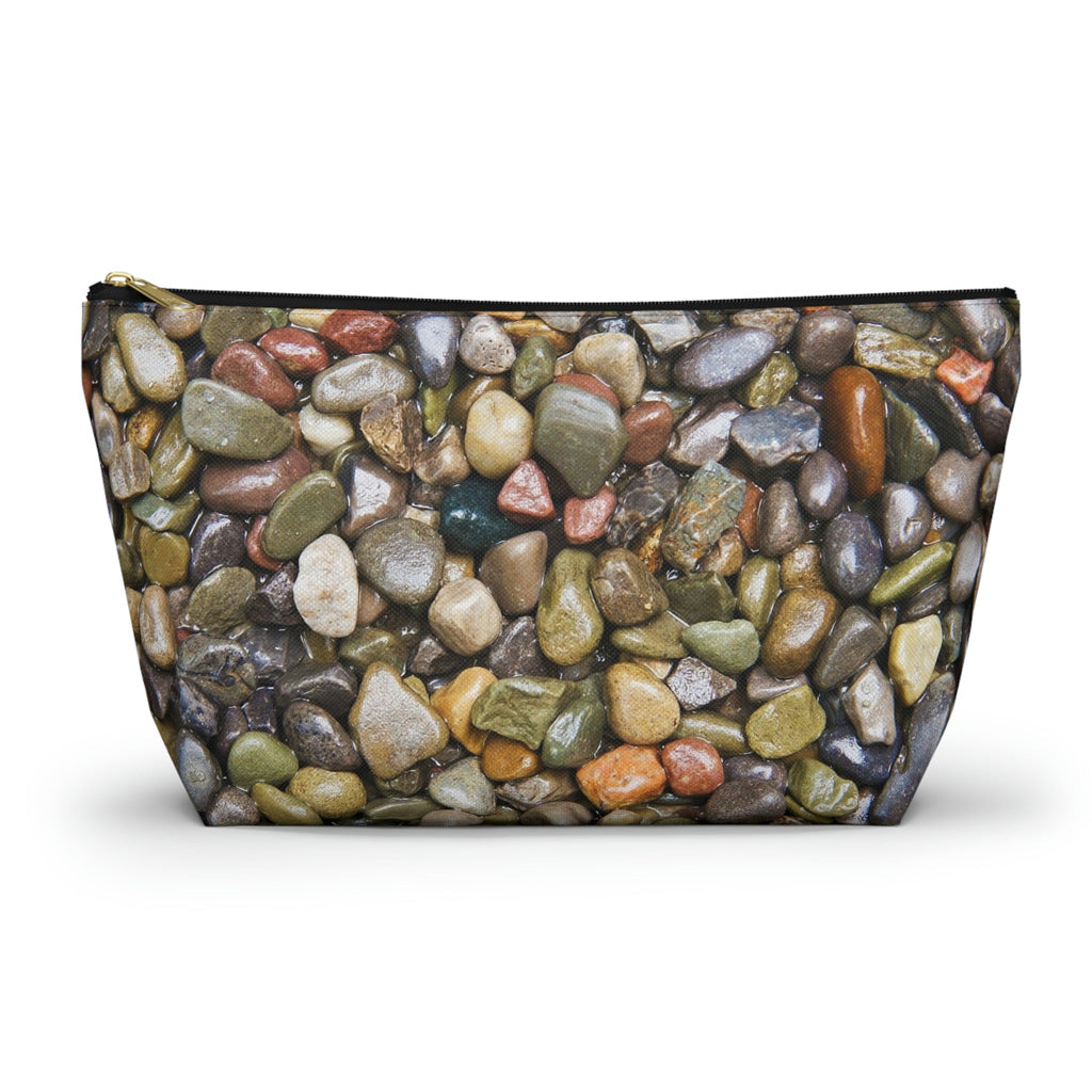 Zippered kit bag featuring vibrant photo art close up of wet glistening multi colored pebbles and stones.
