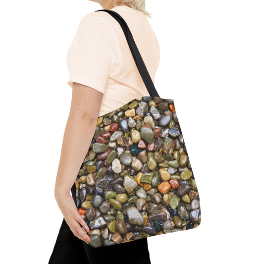 Young woman with a tote bag featuring the pebbles and stones design draped across her shoulder.