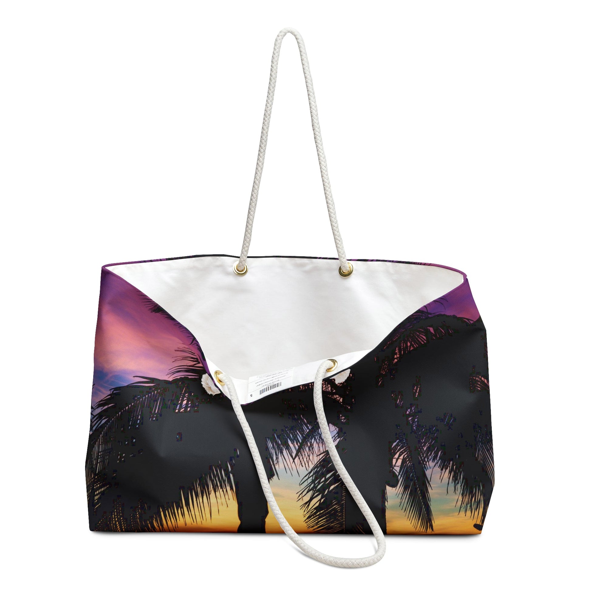An open view of the beach bag with intense sunset design shows the cream colored interior lining.