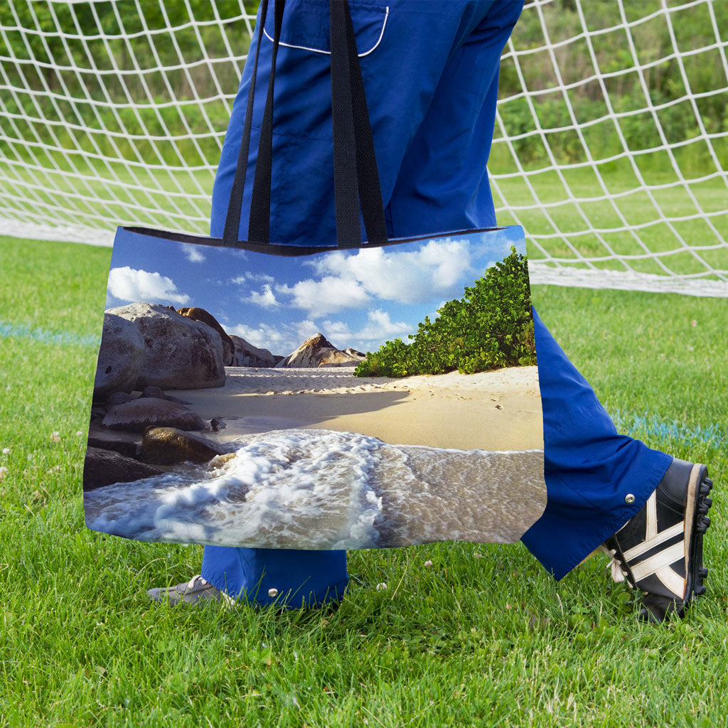 A soccer player carrying a weekender bag featuring the beach surf design onto the practice field.