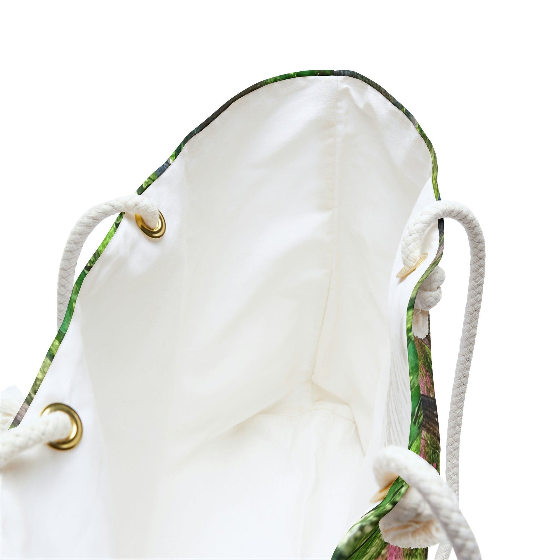 A close up view of the beach bag with wetland design shows the braided rope handles with metal grommets.