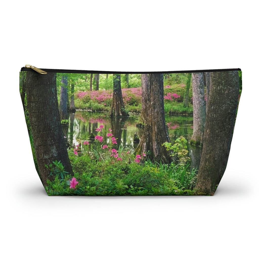 Zippered accessory pouch featuring vibrant photo art of lush green trees and hot pink colored flowers in a Southern wetland.