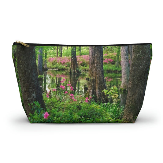 Zippered accessory pouch featuring vibrant photo art of lush green trees and hot pink colored flowers in a Southern wetland.