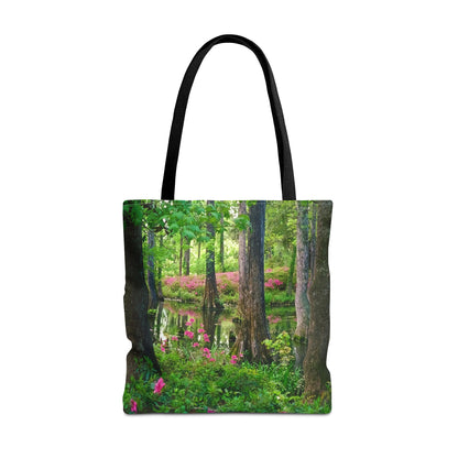 Large 18 x 18 inch tote bag featuring vibrant photo art of lush green trees and hot pink colored flowers in a Southern wetland. 
