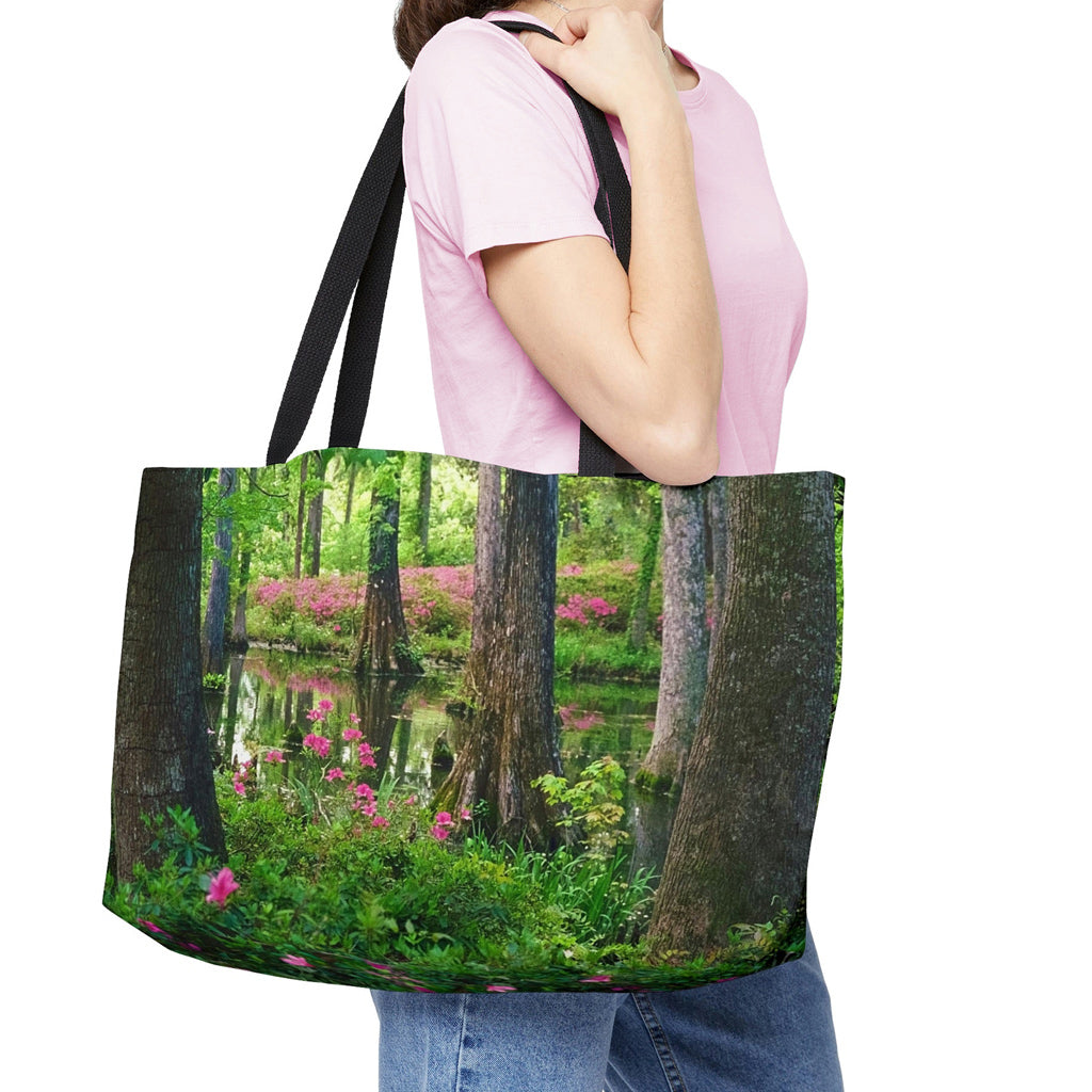 Young woman with a weekender bag featuring the wetland design hanging from her shoulder.