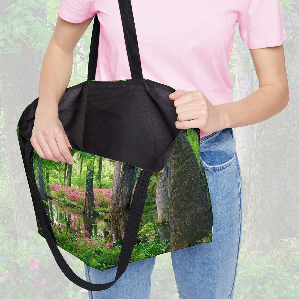 A woman holding open a weekender bag featuring the wetland design, showcasing the roomy interior.