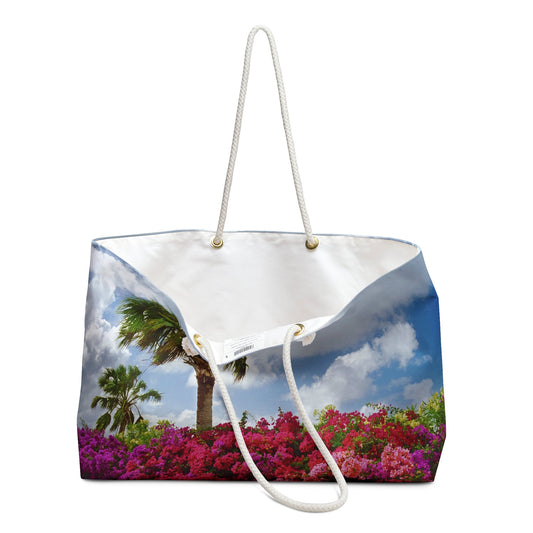 An open view of the beach bag with tropical flowers design shows the cream colored interior lining.