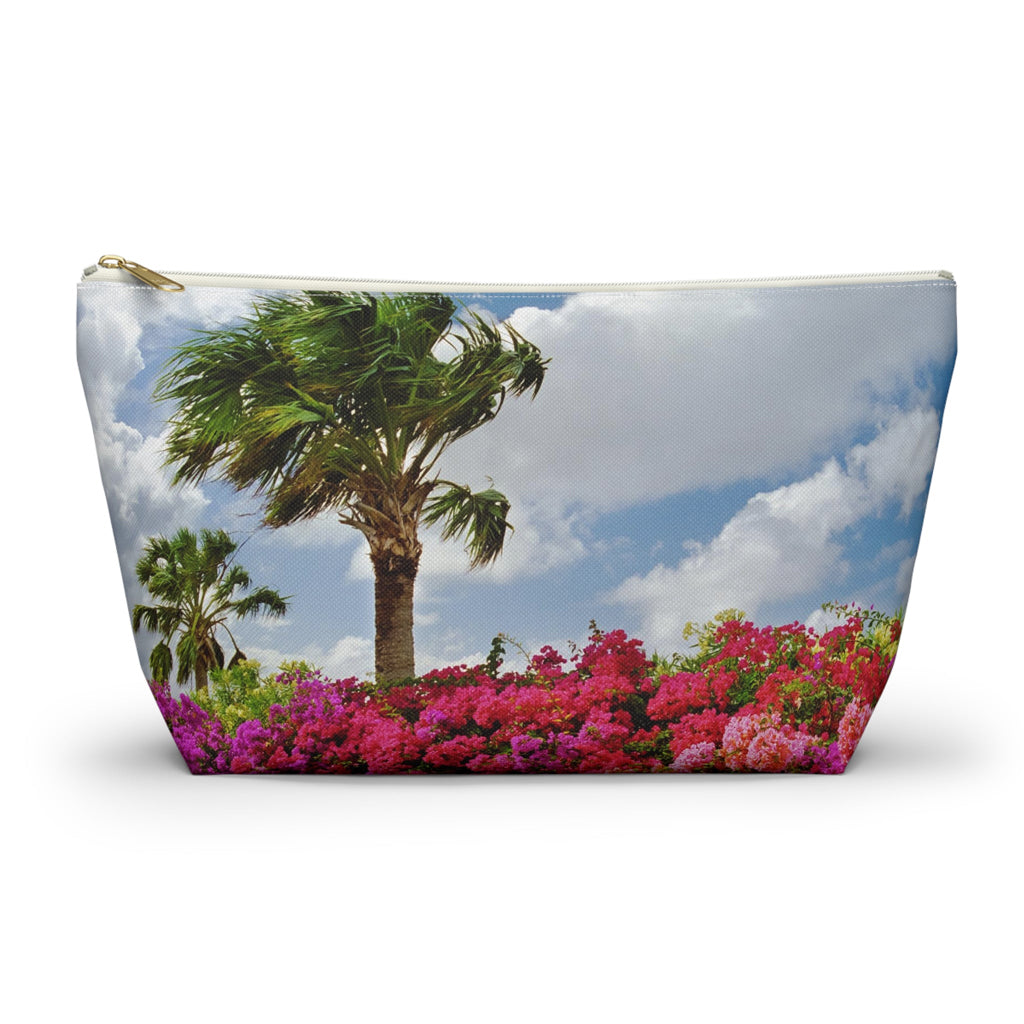 Zippered accessory pouch featuring vibrant photo art of a bright blue sky, windy palm trees and brilliant tropical flowers.