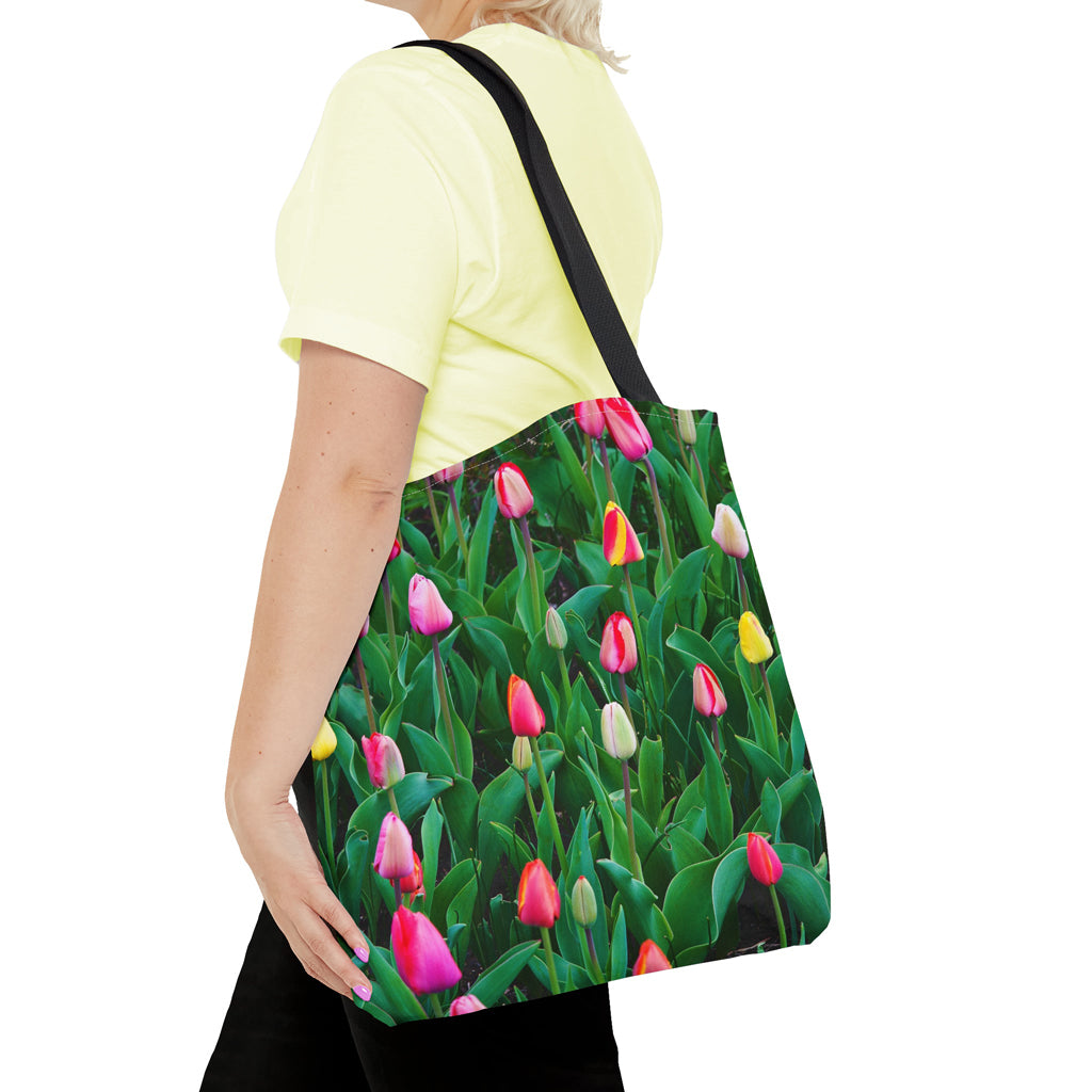 Young woman with a tote bag featuring the multi colored tulips design draped across her shoulder.
