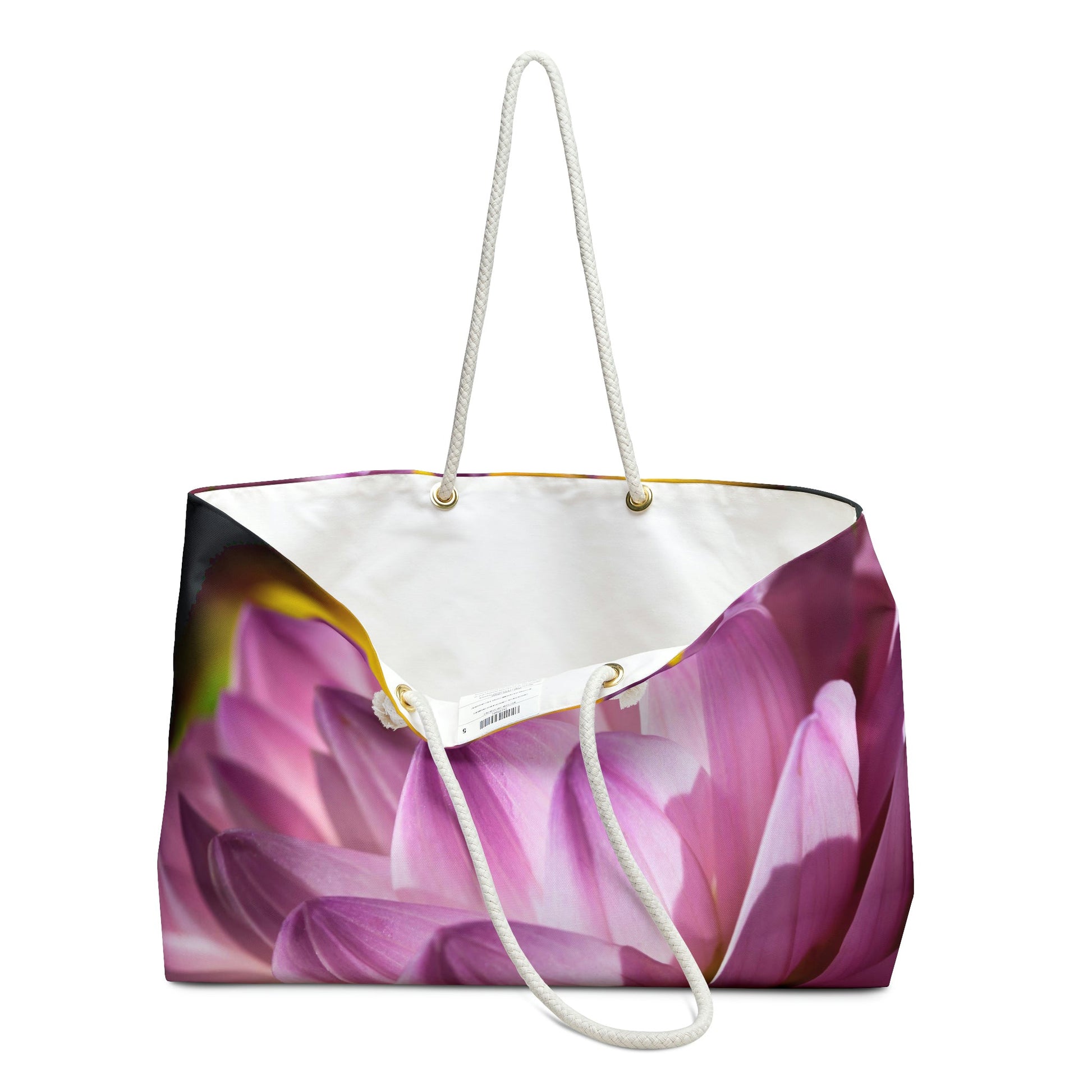 An open view of the beach bag with flower petals design shows the cream colored interior lining.