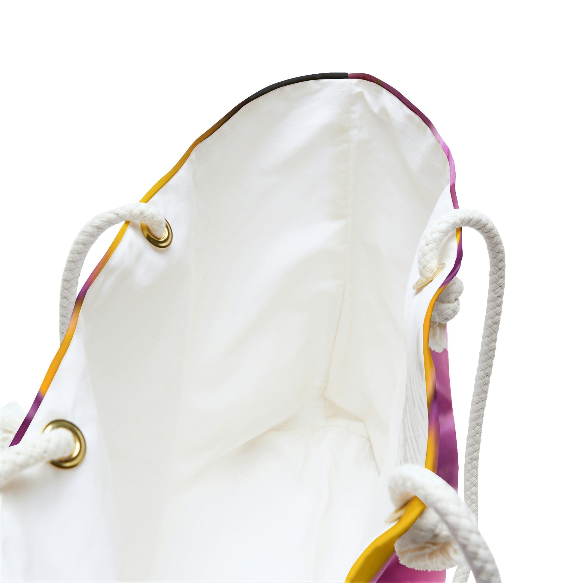 A close up view of the beach bag with flower petals design shows the braided rope handles with metal grommets.