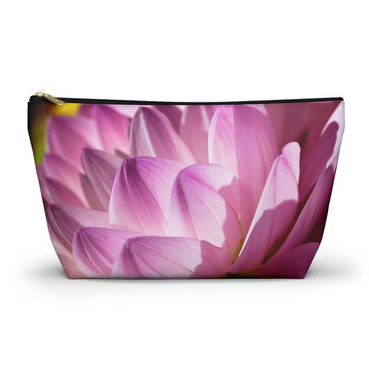 Zippered accessory pouch featuring a vibrant photo art close up of pinkish violet colored flower petals in warm sunset light.