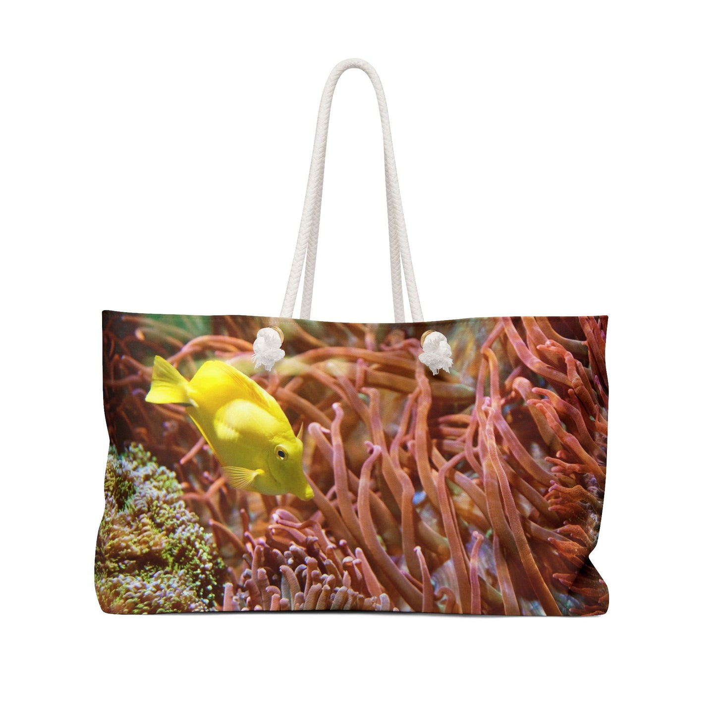 Front view of a beach bag featuring vibrant photo art of a bright yellow fish swimming among sea anemones and plants.